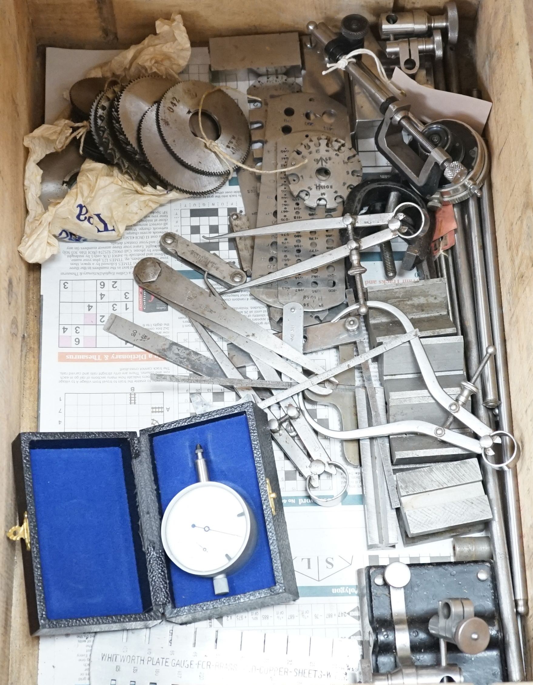 A collection of 20th century high precision metal measuring devices, including callipers, Compac dial micrometers, feeler gauges, wire gauges, a set square, steel cutting wheels etc